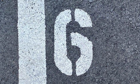 A white number 6, painted in a stencil style, is marked on dark asphalt next to a thick white line—like a curated list assigning each parking space its spot, evoking November 19 2024’s spirit of leadership and order. A white number 6, painted in a stencil style, is marked on dark asphalt next to a thick white line—like a curated list assigning each parking space its spot, evoking November 19 2024’s spirit of leadership and order.